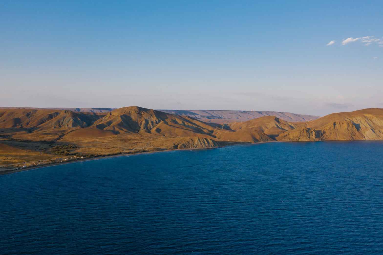 brown mountains near body of water